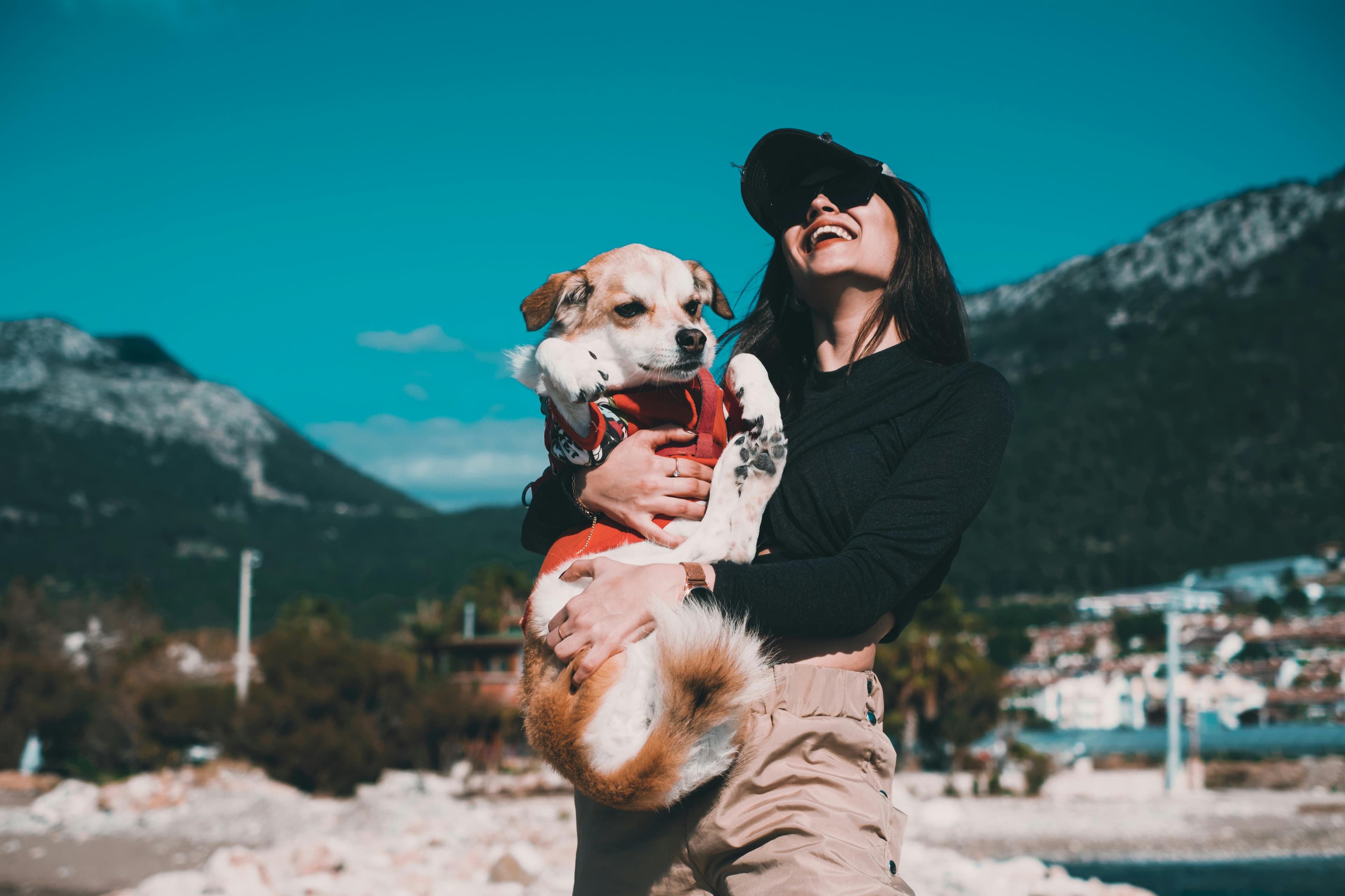 Woman laughing with her dog outdoors